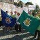 Grupo de pessoas com bandeiras azul e verde das Freguesias de Cortiçô e Vila Chã em rua